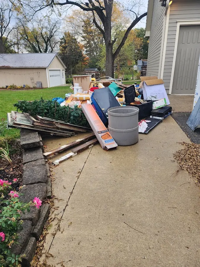Dumpster being loaded with debris for Estate Cleanout Dumpster Rental in Brandon